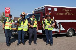 4 firefifghters standing in front of Strasburg Fire ambulance for Fill the Boot